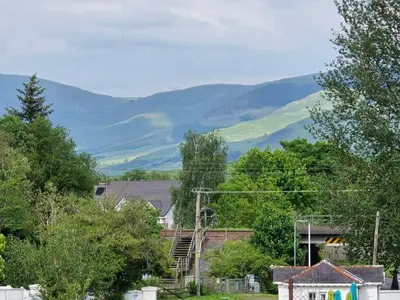 a town with mountains in the background at Luxury static caravan in Beattock