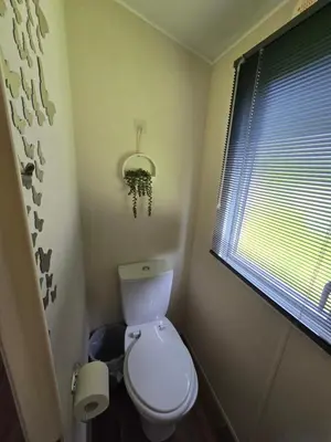 a small bathroom with a toilet and a window at Luxury static caravan in Beattock