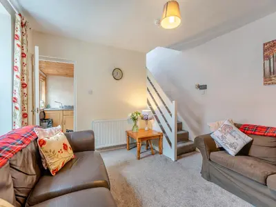 a living room with a couch and a table at Carraig Dhubh North - Uk47125 in Whiting Bay