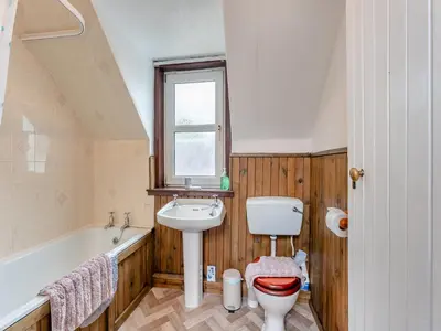 a bathroom with a toilet and a sink and a bath tub at Carraig Dhubh North - Uk47125 in Whiting Bay