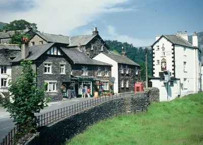 a group of buildings on the side of a street at Patterdale Hotel in Patterdale