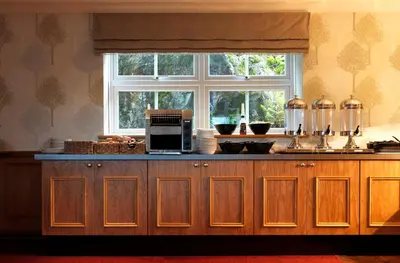 a kitchen with a counter with a microwave and a window at Patterdale Hotel in Patterdale