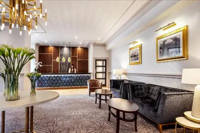 a lobby with couches and tables and a bar at The Inn On The Lake in Glenridding
