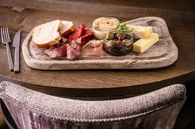 a plate of meat and cheese and bread on a table at The Inn On The Lake in Glenridding