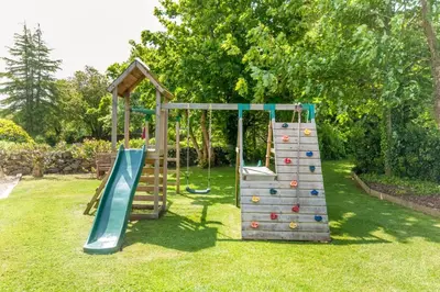 a playground with a slide and a climbing frame at Courtyard Cottages Rose Cottage in Wigtown