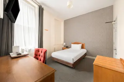 a hotel room with a bed and a desk at The County Hotel in Carlisle