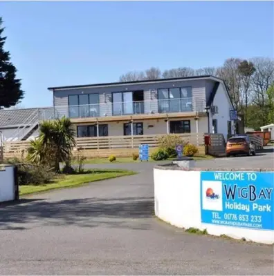 a large house with a sign in front of it at Static Caravan situated at Wigbay, Stranraer in Stranraer