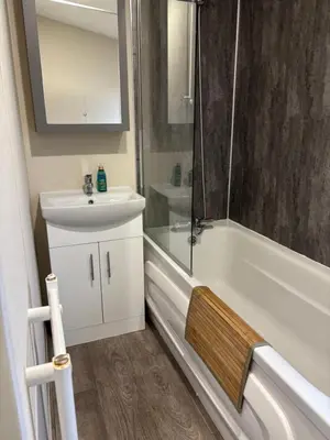 a bathroom with a sink and a tub and a shower at Forestbrook - Cheerful two bedroom tiny house in Carlisle