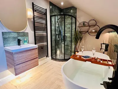 a large bathroom with a tub and a shower at Longbank Luxury Lets in Ayr