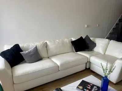 a white couch with pillows on it in a living room at Birks road in Cleator Moor
