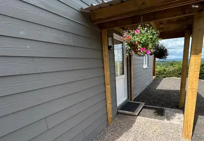 a door to a house with a flower basket on it at Castle Glen Lodge in Dumfries