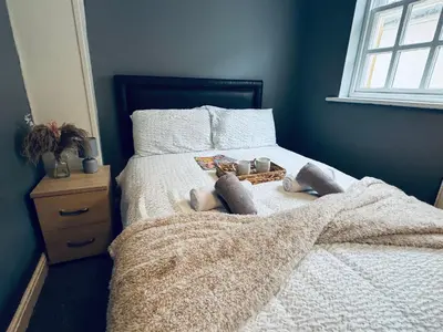a bedroom with a bed with two stuffed animals on it at Queens Townhouse - 4 Bedrooms - Sleeps 9 in Whitehaven