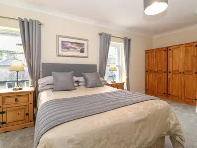a bedroom with a large bed and a window at Melbreak House 2 in Keswick