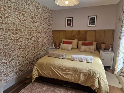 a bedroom with a large bed and a wall mural at The Drey by Blake view holidays, a peaceful boutique retreat, 3 miles from Ennerdale- small twin or king bed available in Arlecdon