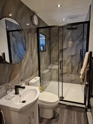 a bathroom with a sink and a toilet and a shower at The Drey by Blake view holidays, a peaceful boutique retreat, 3 miles from Ennerdale- small twin or king bed available in Arlecdon