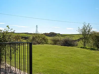 a gate in the middle of a field of grass at Bengairn in Ringford