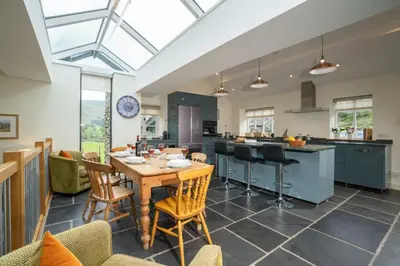 a kitchen with a table and chairs in a room at Panoramic Views & Spacious Living by LetMeStay in Grasmere