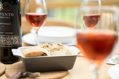 a table with a bowl of bread and two glasses of wine at Panoramic Views & Spacious Living by LetMeStay in Grasmere