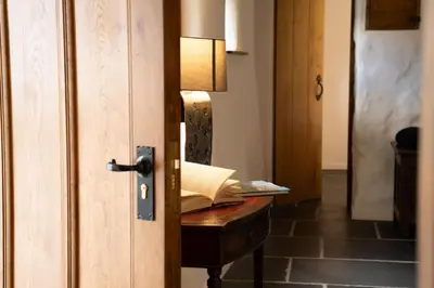 an open door with a book on a desk with a lamp at Panoramic Views & Spacious Living by LetMeStay in Grasmere