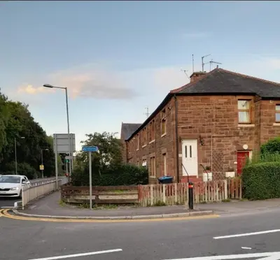 a brick building on the side of a street at Smriti's in Dumfries