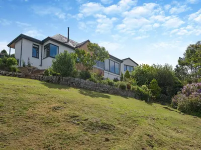 a house on top of a grassy hill at Berkeley in Kippford