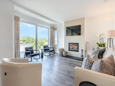 a living room with a couch and a fireplace at Berkeley in Kippford