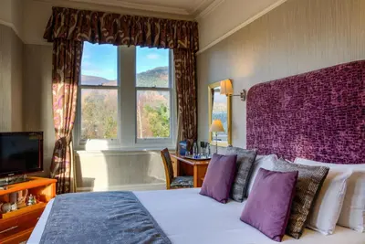 a hotel room with a bed and a window at Keswick Country House Hotel in Keswick
