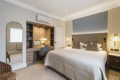 a bedroom with a bed and a desk with a computer at Skiddaw Hotel in Keswick