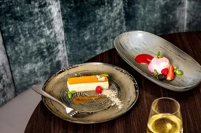 a plate with a piece of cake on a table at Skiddaw Hotel in Keswick