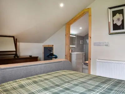 a bedroom with a bed and a sink and a refrigerator at Uk46833 - Low Hollas Farmhouse in Threlkeld