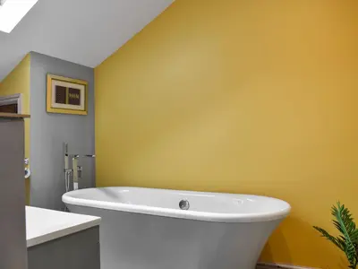 a bath tub in a bathroom with a yellow wall at Uk46833 - Low Hollas Farmhouse in Threlkeld