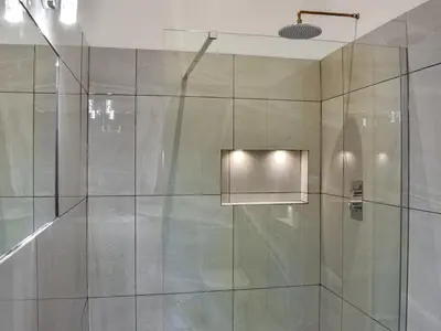 a bathroom with a shower with a glass door at Uk46833 - Low Hollas Farmhouse in Threlkeld