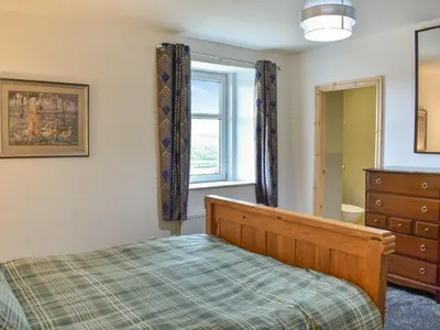 a bedroom with a bed and a window and a dresser at Uk46833 - Low Hollas Farmhouse in Threlkeld