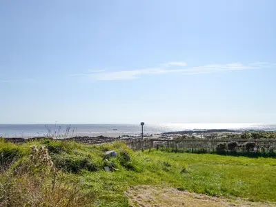 a beach with the ocean in the background at Merse Place 57- Uk46905 in Mainsriddle