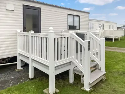 a white wooden ramp leading up to a mobile home at Merse Place 57- Uk46905 in Mainsriddle