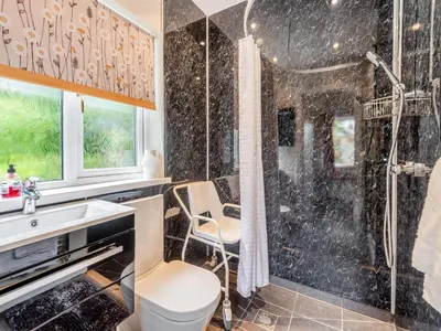 a bathroom with a shower and a sink at Stackgarth in Gilcrux
