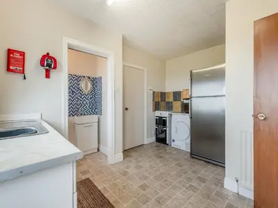 a kitchen with a sink and a refrigerator at Stackgarth in Gilcrux