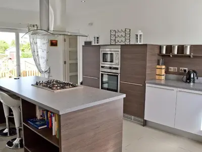 a kitchen with a counter and a stove top oven at Bengali in Ringford