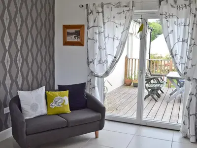 a living room with a chair and a balcony at Bengali in Ringford