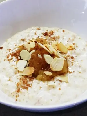 a white bowl of food with nuts on it at Lakeside Country Guest House in Bassenthwaite Lake