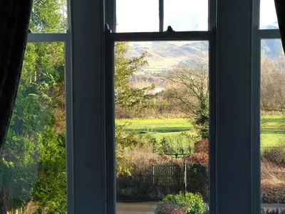 a window with a view of a green field at Lakeside Country Guest House in Bassenthwaite Lake
