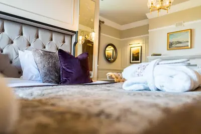 a hotel room with a bed with towels on it at Armathwaite Hall Hotel & Spa in Bassenthwaite