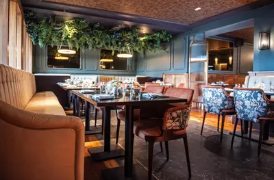 a restaurant with tables and chairs in a room at Armathwaite Hall Hotel & Spa in Bassenthwaite
