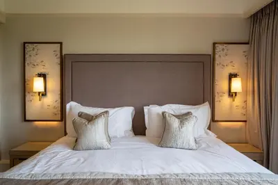a bedroom with a white bed with two pillows at Armathwaite Hall Hotel & Spa in Bassenthwaite