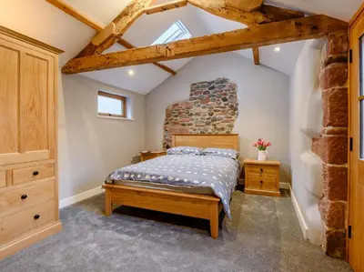 a bedroom with a bed and a brick wall at 2 Bed in Dalston 93820 in Dalston