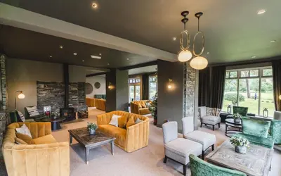 a living room with couches and a fireplace at Borrowdale Gates Hotel in Keswick