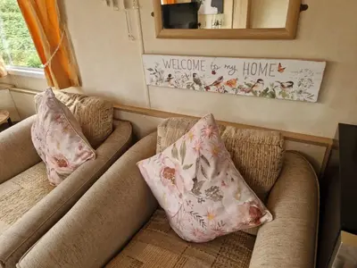 two pillows on a couch in a living room at Lochview Retreat Caravan in Balminnoch