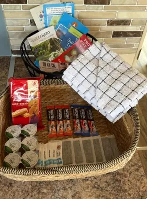 a wicker basket with food and drinks on it at Lochview Retreat Caravan in Balminnoch