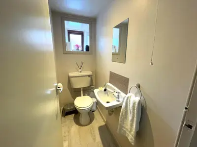 a bathroom with a toilet and a sink and a mirror at Charming Cosy Traditional Scottish Cottage - Pass the Keys in Castle Douglas