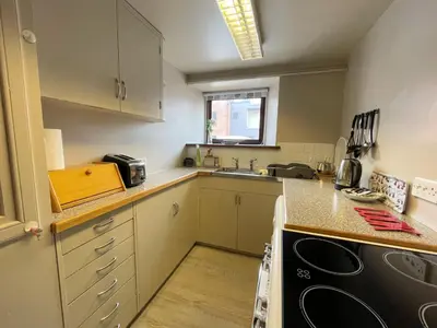 a small kitchen with a sink and a stove at Charming Cosy Traditional Scottish Cottage - Pass the Keys in Castle Douglas